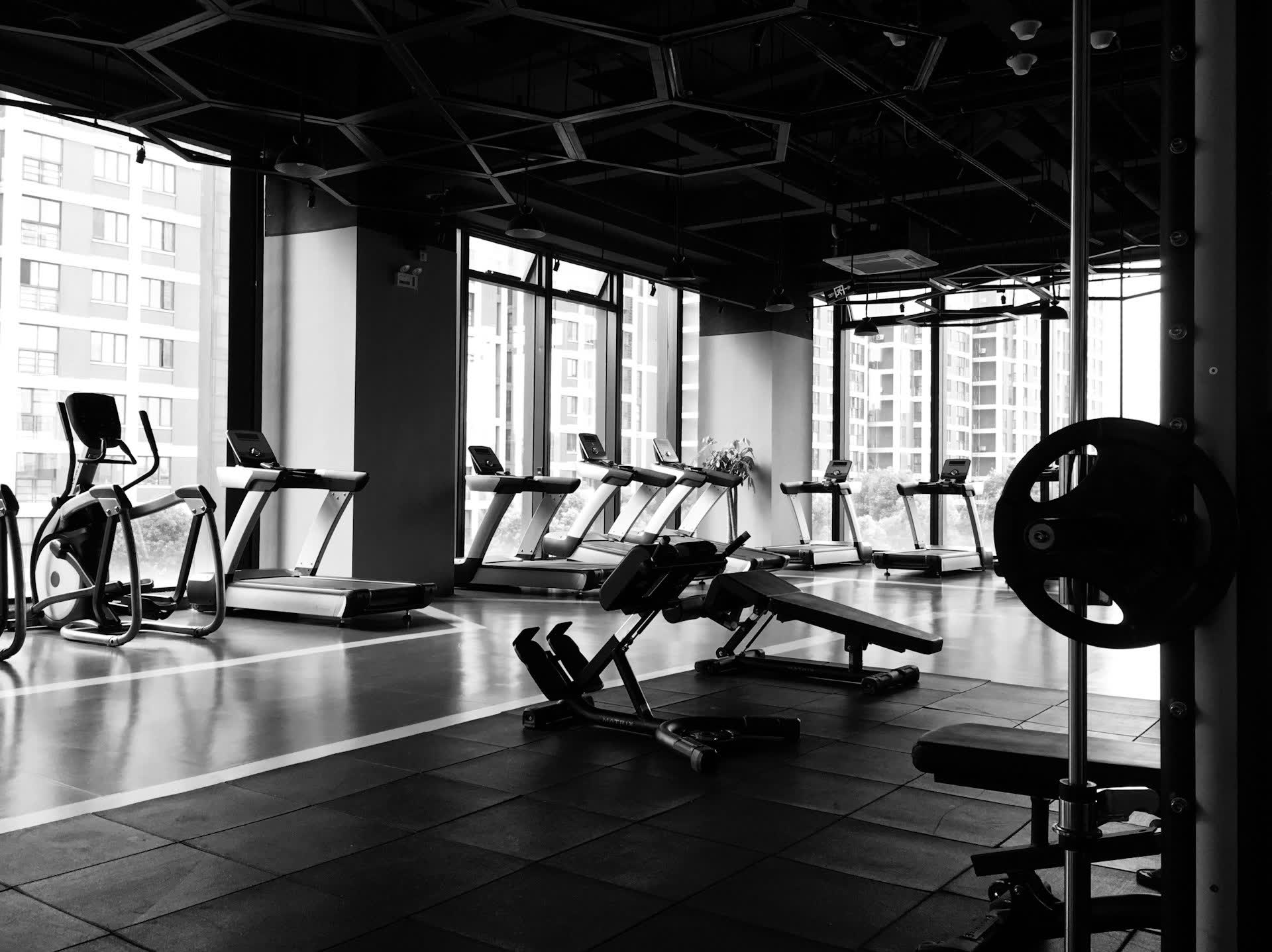 A gym floor of machines, quiet and dark after hours